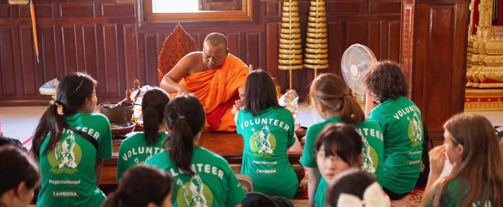 Participants receive a blessing from a priest in Cambodia